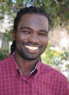 Smiling man with a pink checkered shirt